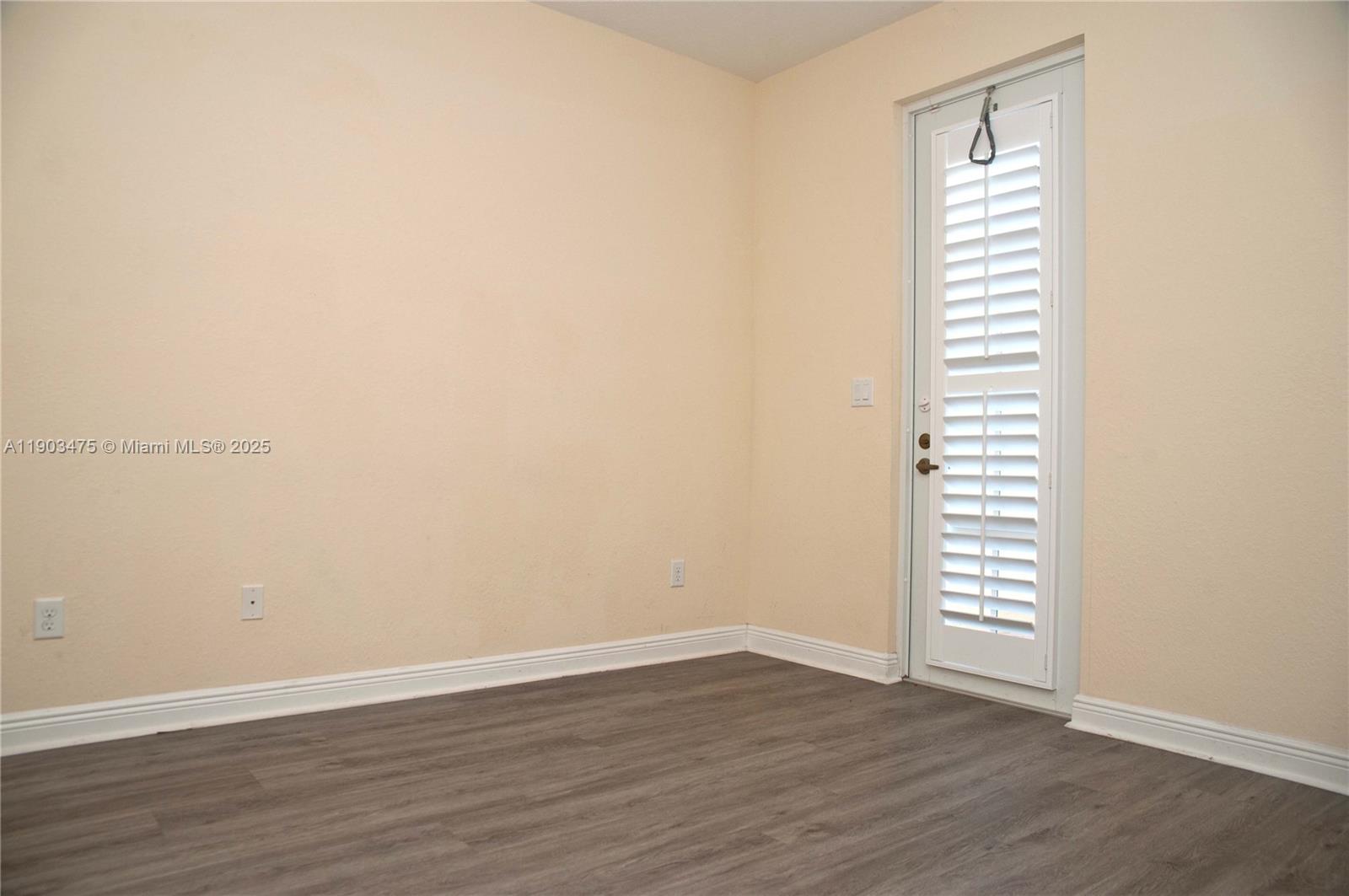 14620 Southwest 15th Street Pembroke Pines, FL 33027 - Photo 16 of 59 an empty room with wooden floor and a window