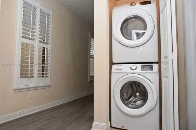 a view of entryway and hall with wooden floor
