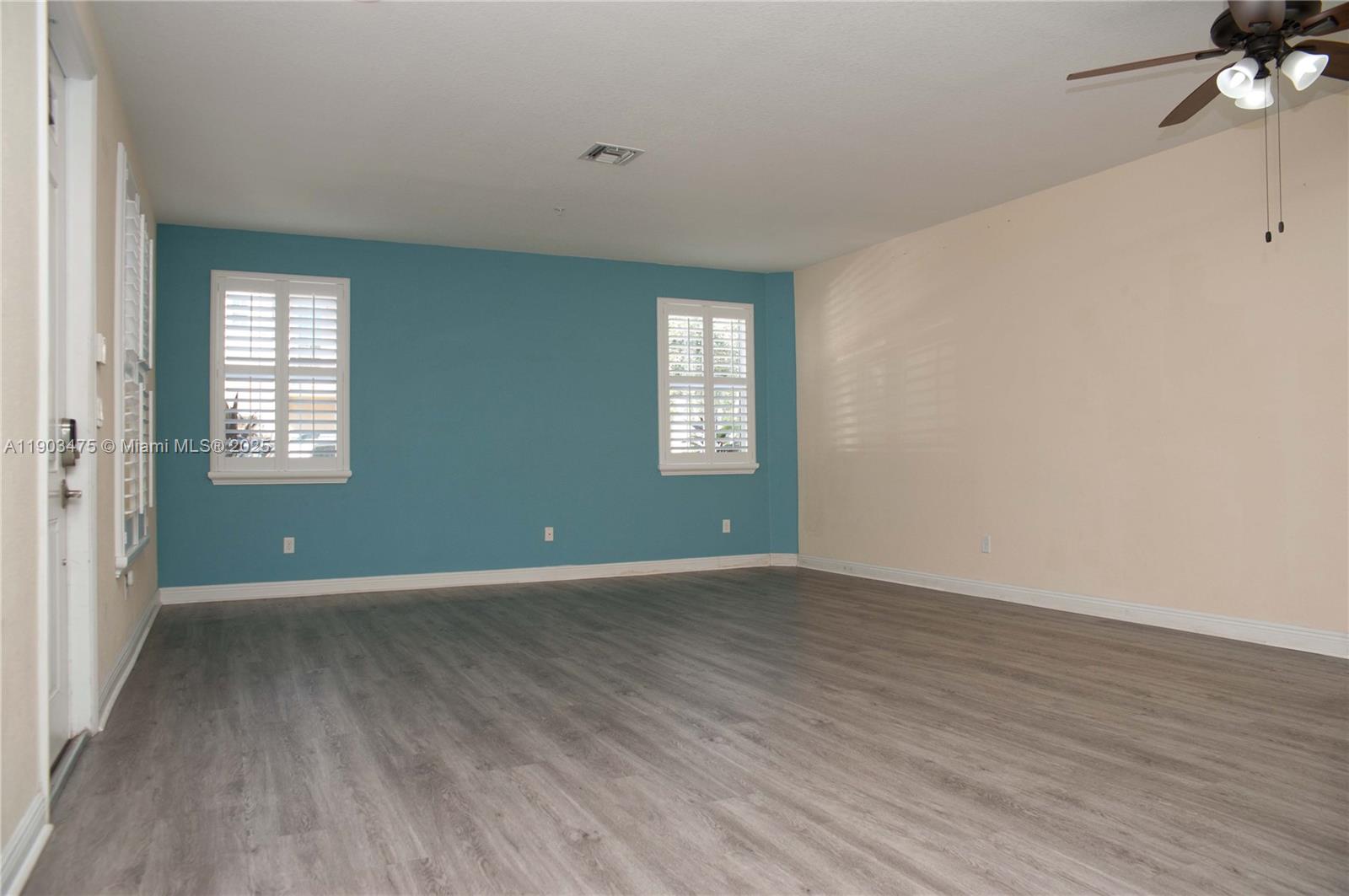 14620 Southwest 15th Street Pembroke Pines, FL 33027 - Photo 22 of 59 an empty room with wooden floor and windows