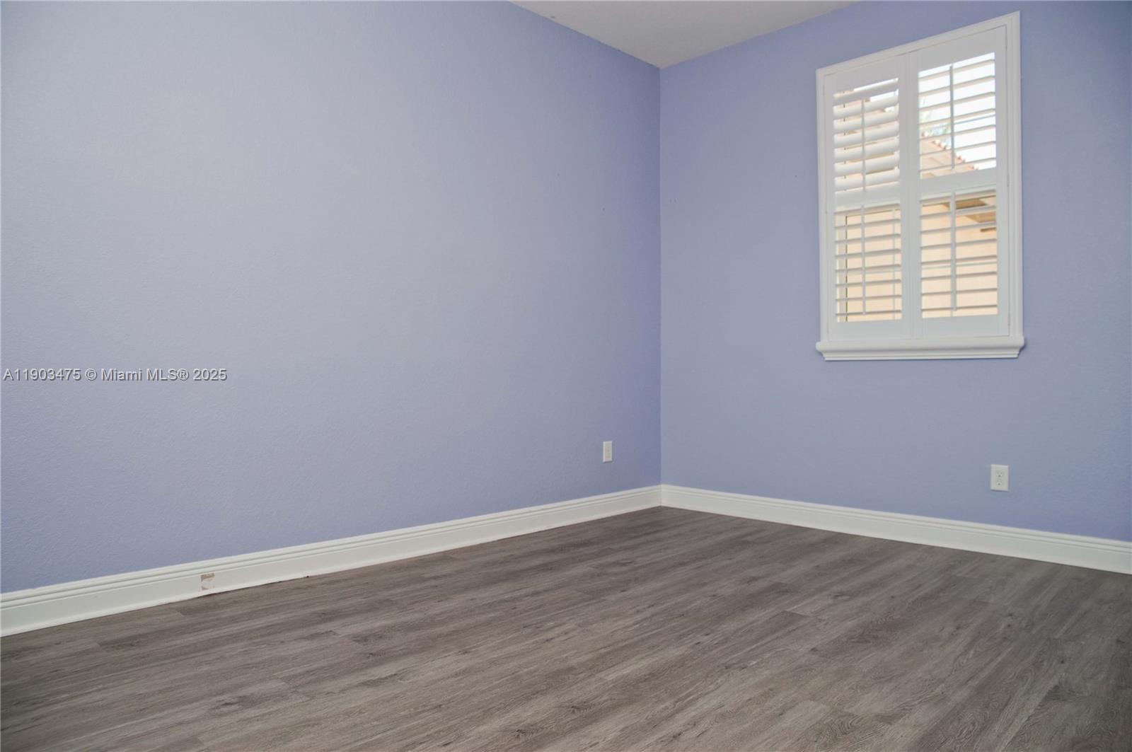 14620 Southwest 15th Street Pembroke Pines, FL 33027 - Photo 31 of 59 an empty room with wooden floor and windows
