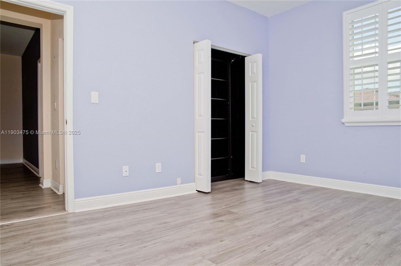 14620 Southwest 15th Street Pembroke Pines, FL 33027 - Photo 33 of 59 an empty room with wooden floor and windows