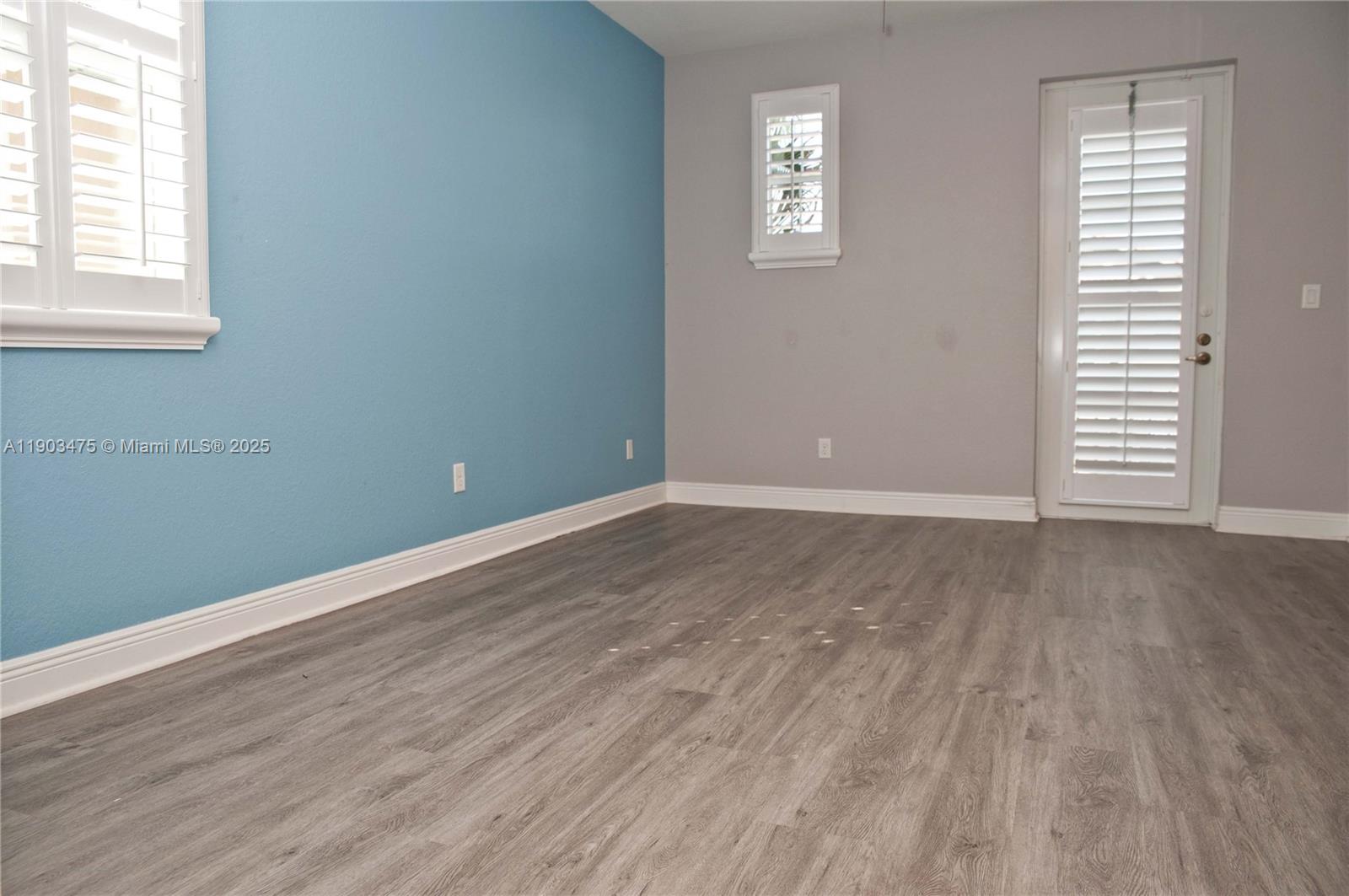14620 Southwest 15th Street Pembroke Pines, FL 33027 - Photo 38 of 59 an empty room with wooden floor and windows