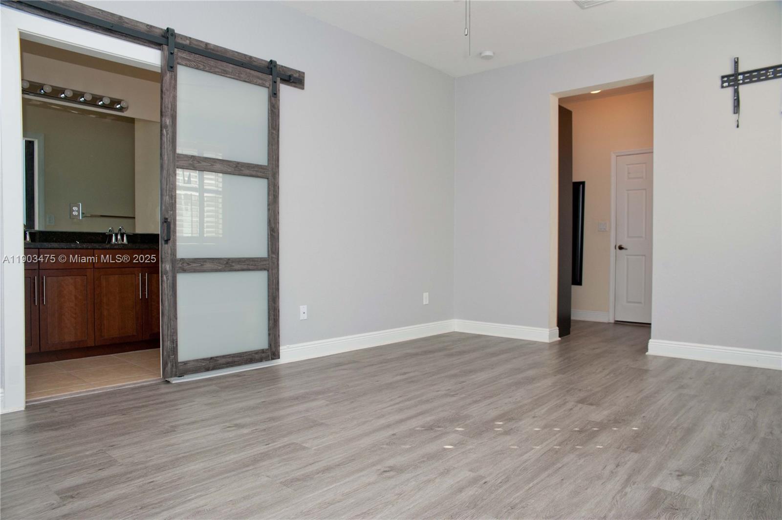 14620 Southwest 15th Street Pembroke Pines, FL 33027 - Photo 40 of 59 an empty room with wooden floor and a cabinet