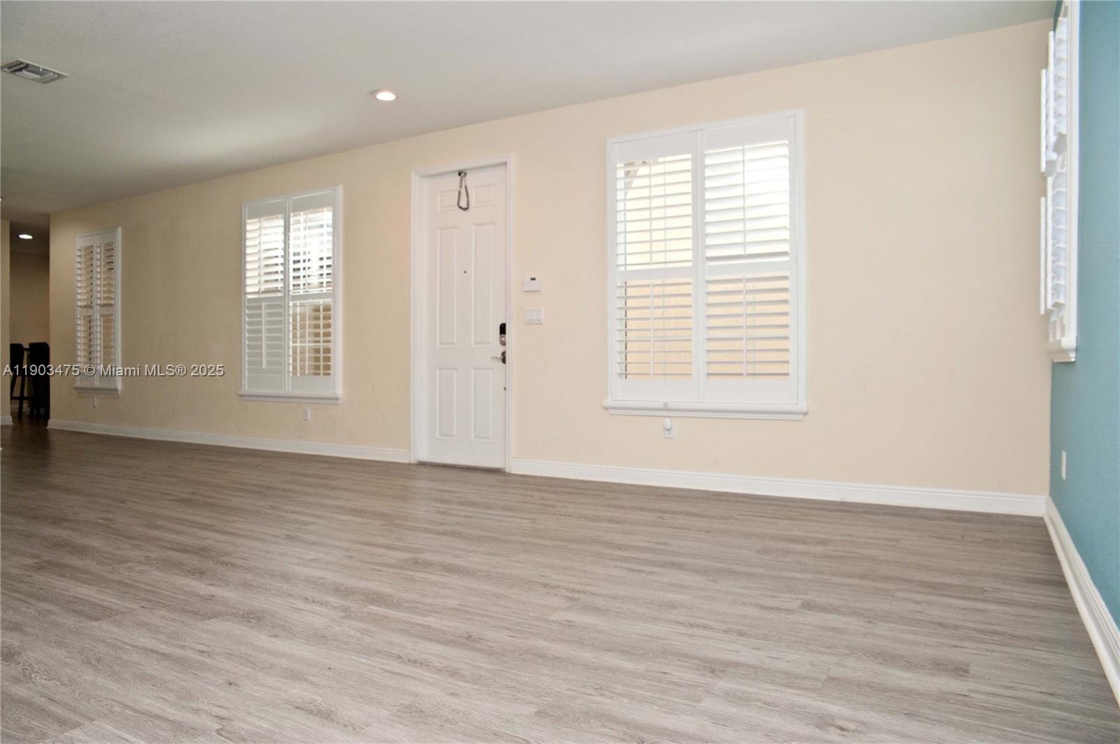 14620 Southwest 15th Street Pembroke Pines, FL 33027 - Photo 4 of 59 an empty room with wooden floor and windows