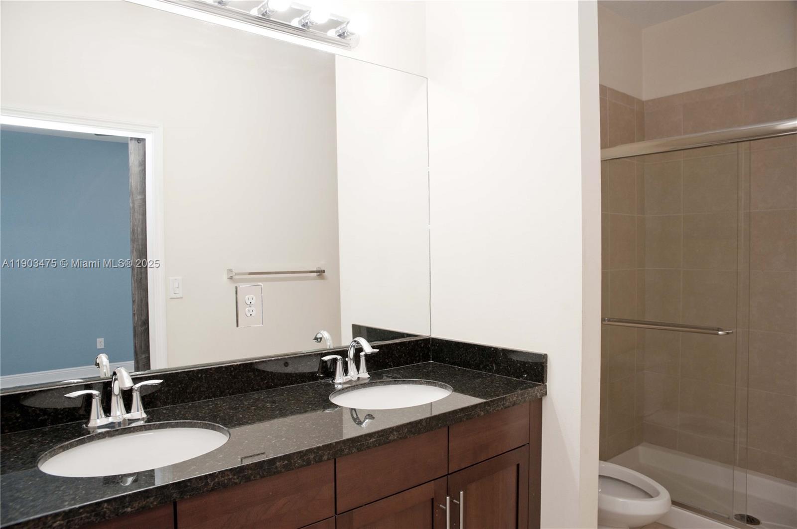14620 Southwest 15th Street Pembroke Pines, FL 33027 - Photo 42 of 59 a bathroom with a granite countertop sink and a mirror