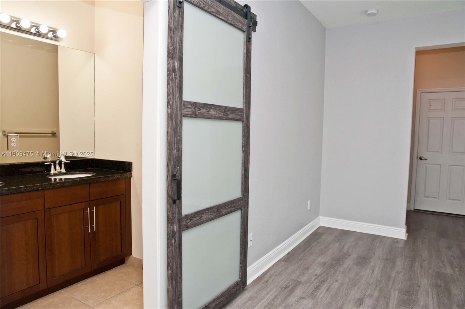 14620 Southwest 15th Street Pembroke Pines, FL 33027 - Photo 44 of 59 a view of walk in closet with wooden floor