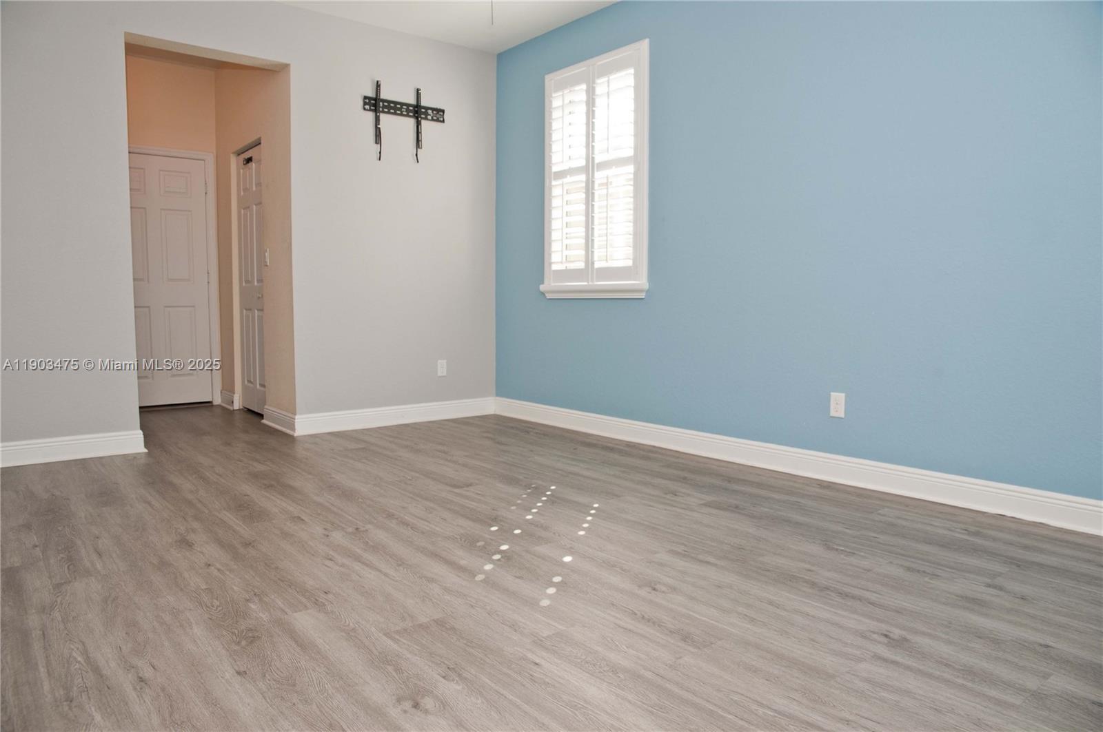 14620 Southwest 15th Street Pembroke Pines, FL 33027 - Photo 45 of 59 an empty room with wooden floor and windows