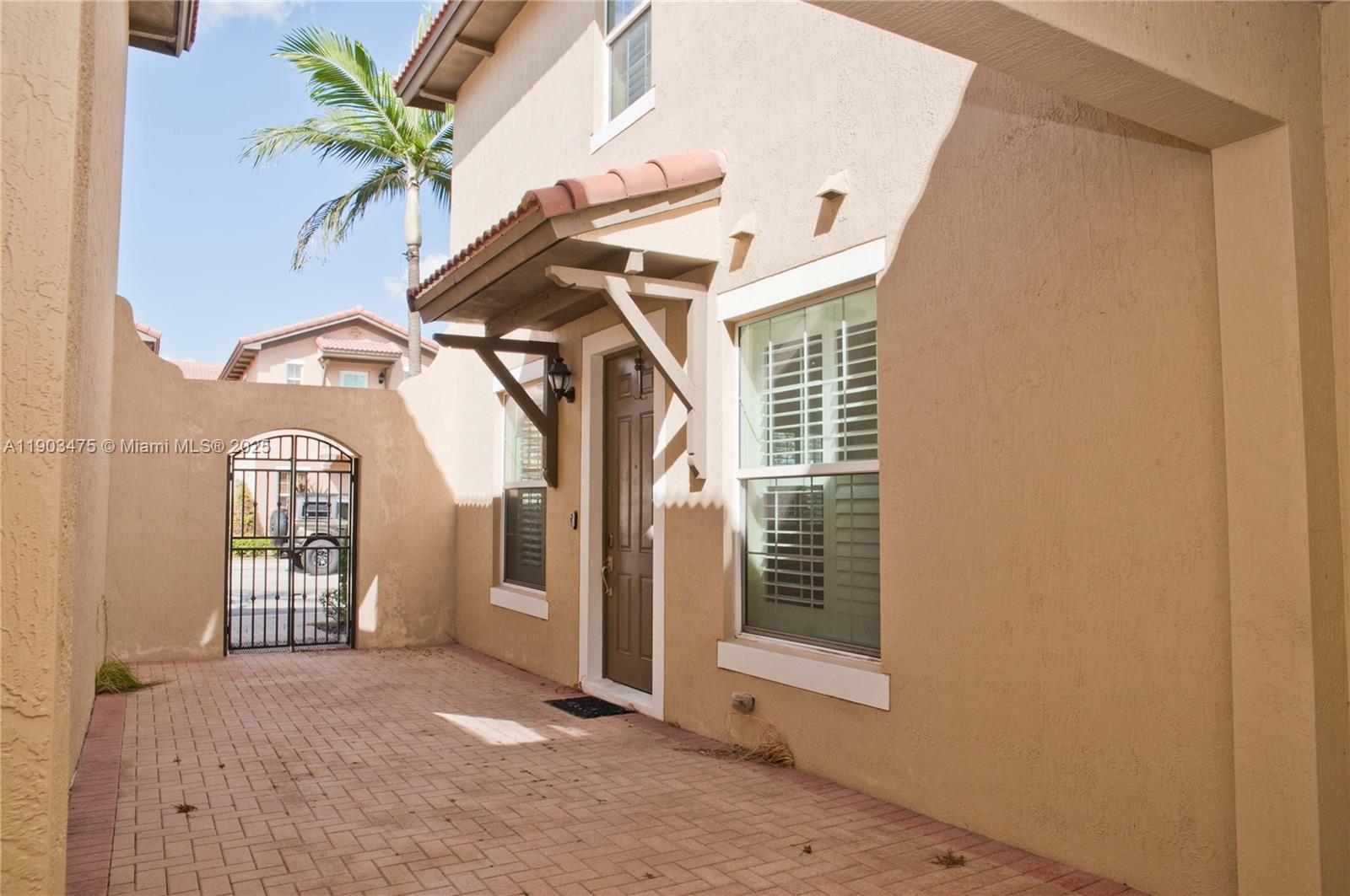 14620 Southwest 15th Street Pembroke Pines, FL 33027 - Photo 49 of 59 a view of a house with a door and wooden door