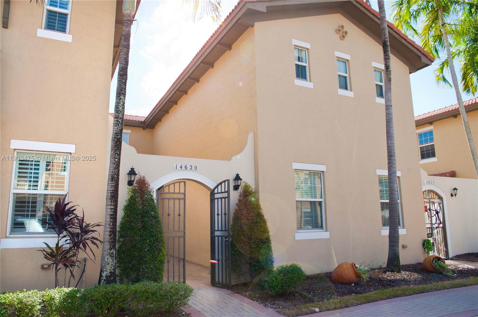 14620 Southwest 15th Street Pembroke Pines, FL 33027 - Photo 50 of 59 a front view of a house with garden