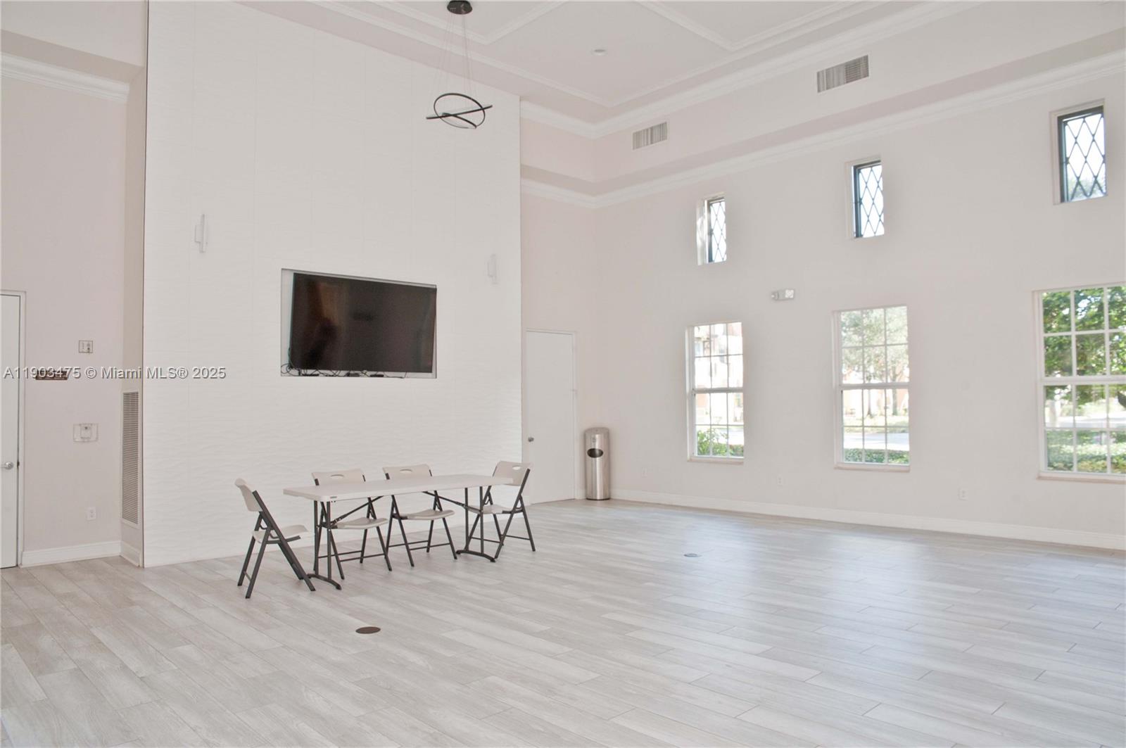 14620 Southwest 15th Street Pembroke Pines, FL 33027 - Photo 57 of 59 a view of an empty room with window and wooden floor