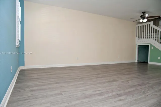 a view of walk in closet with wooden floor