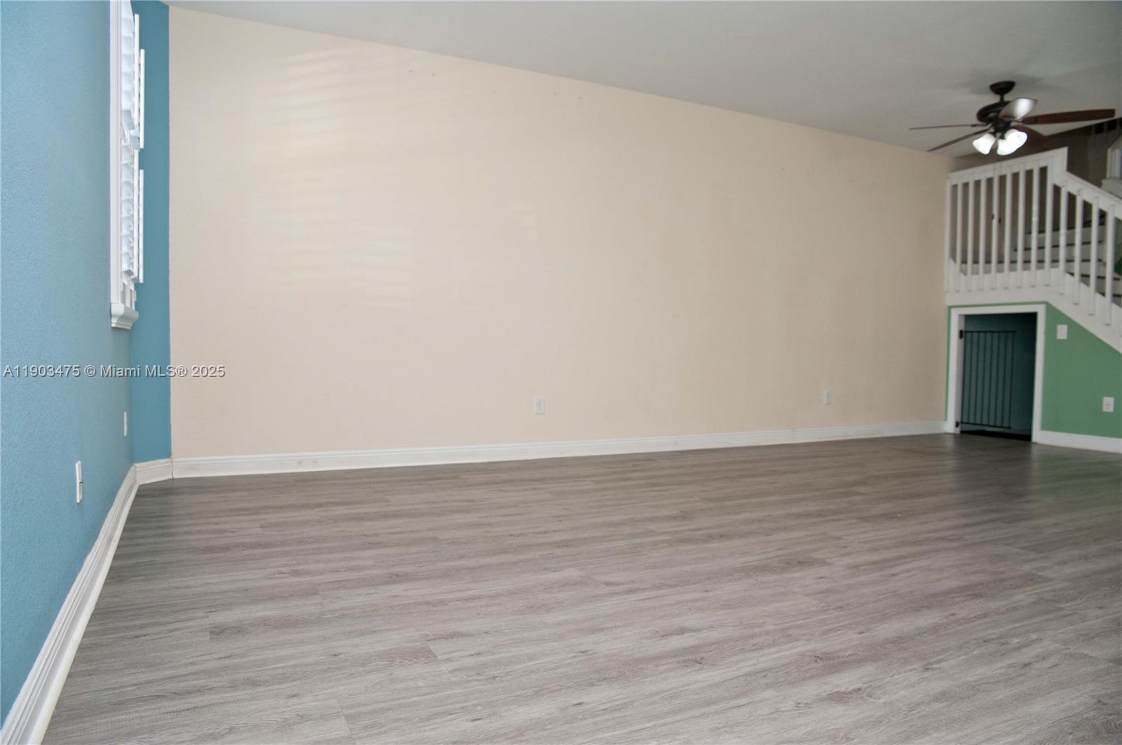 14620 Southwest 15th Street Pembroke Pines, FL 33027 - Photo 9 of 59 a view of an empty room with wooden floor and a window