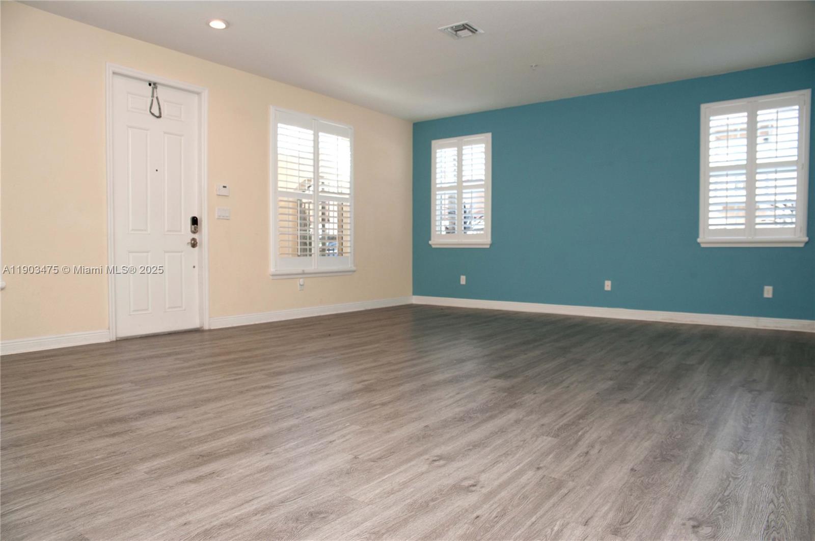 14620 Southwest 15th Street Pembroke Pines, FL 33027 - Photo 10 of 59 an empty room with wooden floor and windows