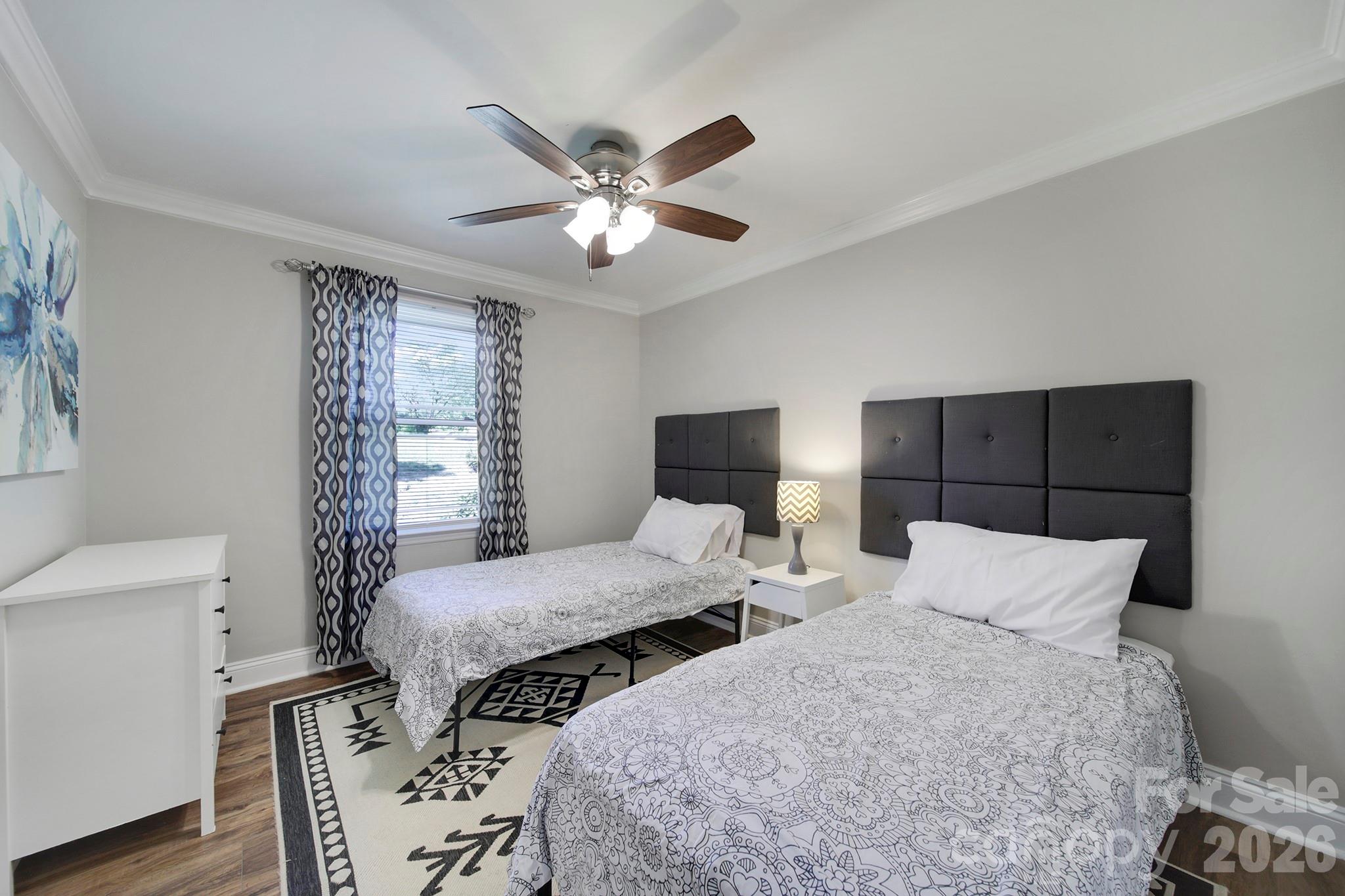 100 Privette Street Fort Mill, SC 29715 - Photo 11 of 25 a bedroom with two beds and a chandelier