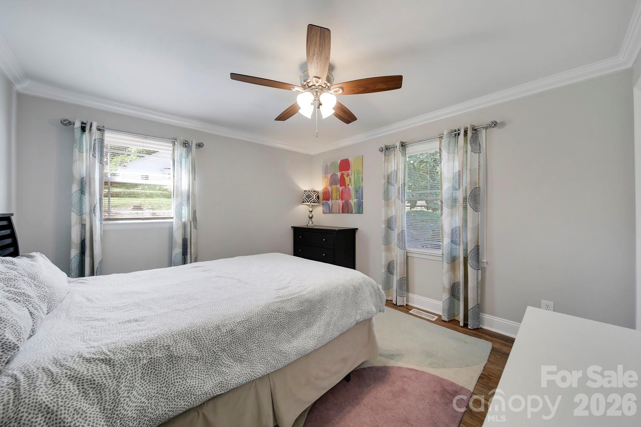 100 Privette Street Fort Mill, SC 29715 - Photo 14 of 25 a bedroom with a bed and a chandelier
