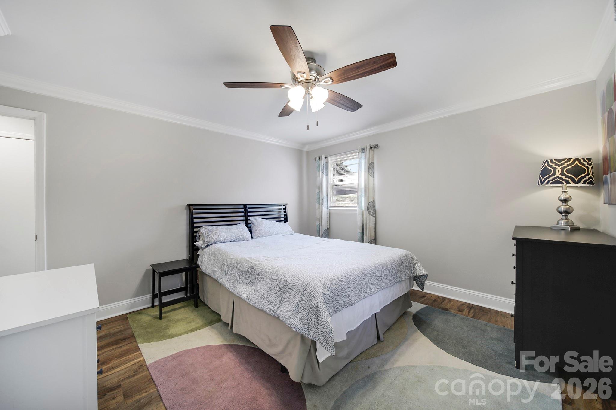 100 Privette Street Fort Mill, SC 29715 - Photo 16 of 25 a bedroom with a bed and a chandelier