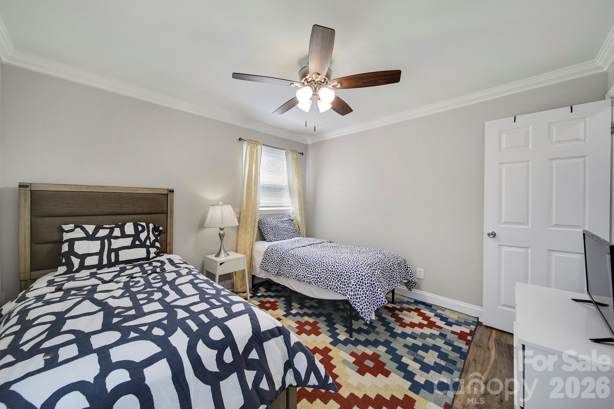 100 Privette Street Fort Mill, SC 29715 - Photo 17 of 25 a bedroom with two beds and a chandelier