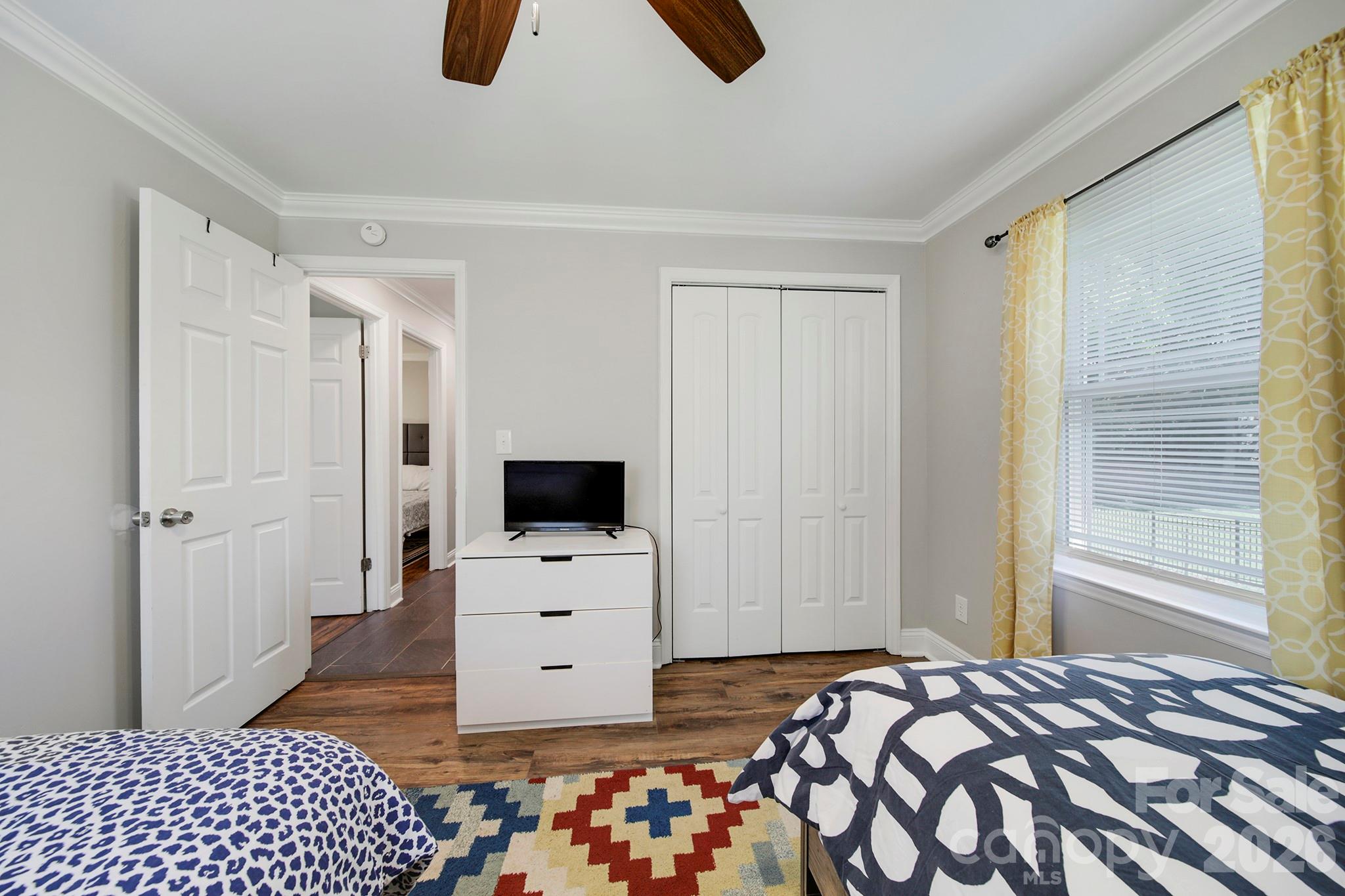 100 Privette Street Fort Mill, SC 29715 - Photo 18 of 25 a bedroom with a bed and flat tv screen on wall