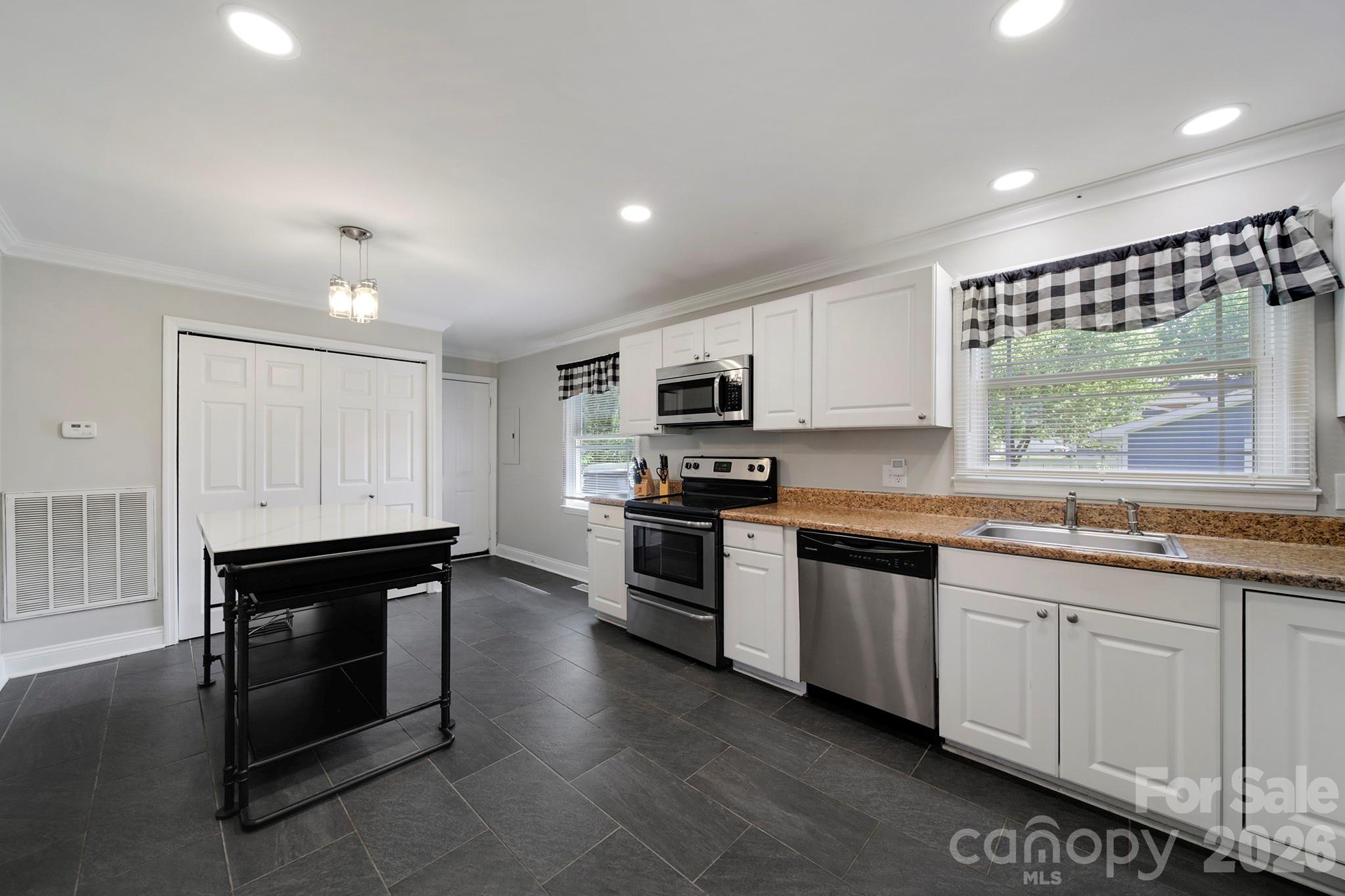 100 Privette Street Fort Mill, SC 29715 - Photo 6 of 25 a kitchen with stainless steel appliances granite countertop a stove a sink and a microwave