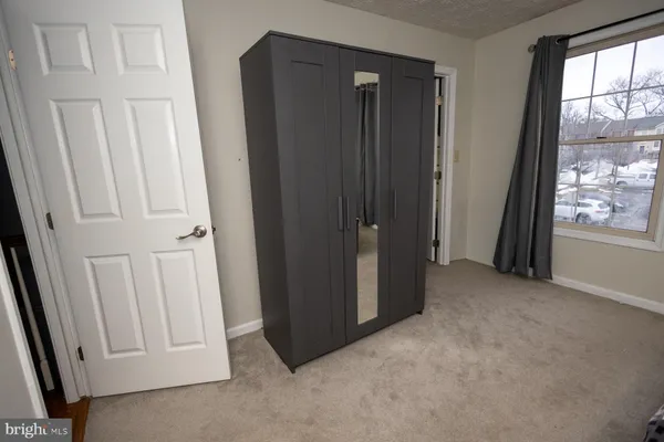 an empty room with windows and closet