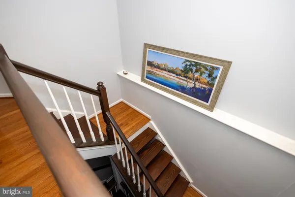 a view of staircase with rug and white walls