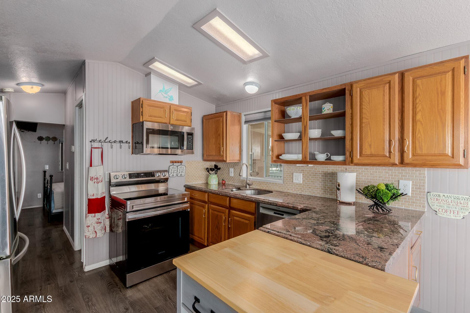 17200 West Bell Road, Unit 1233 Surprise, AZ 85374 - Photo 12 of 41 a kitchen with stainless steel appliances granite countertop a sink stove and refrigerator