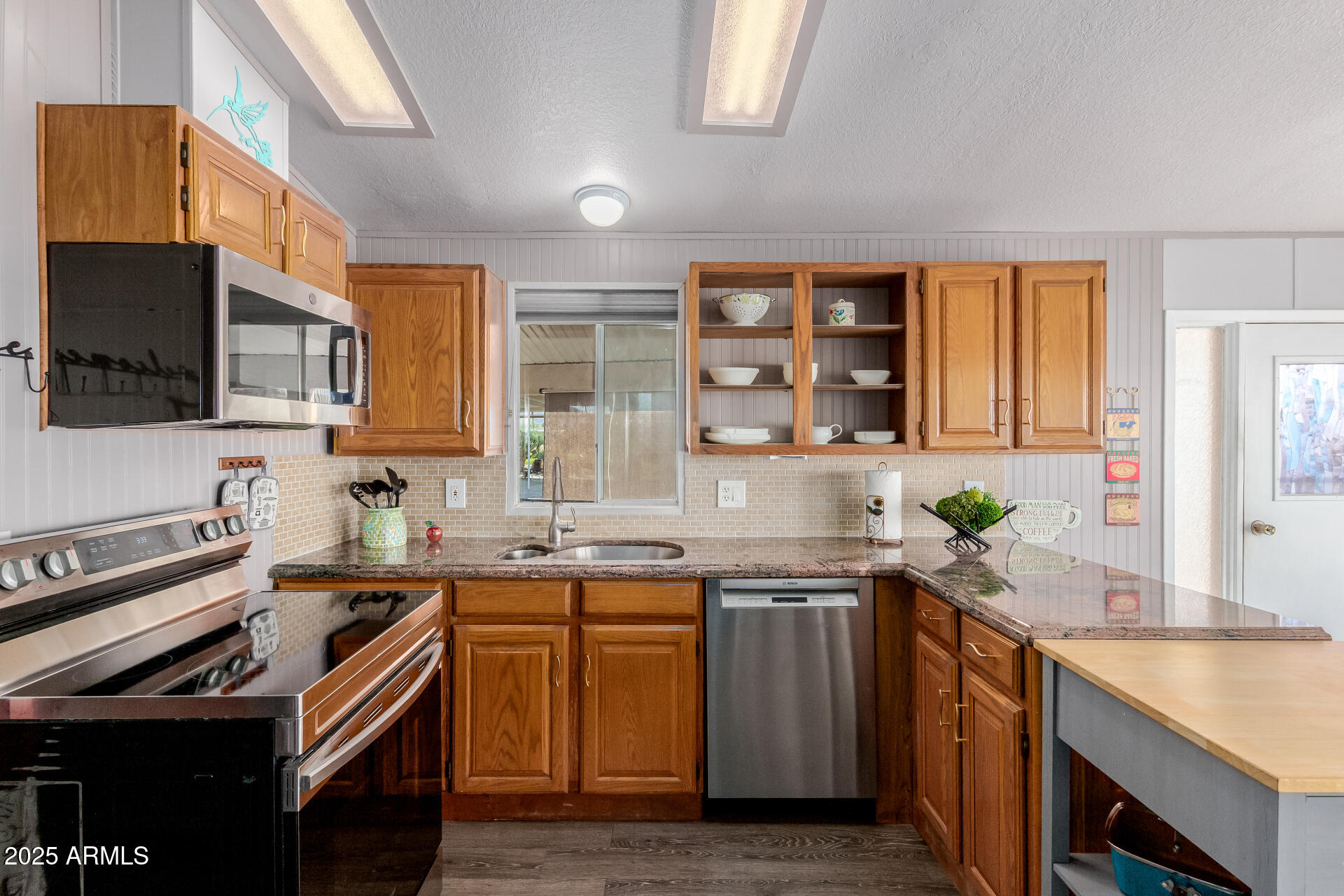 17200 West Bell Road, Unit 1233 Surprise, AZ 85374 - Photo 13 of 41 a kitchen with a sink stove top oven and microwave