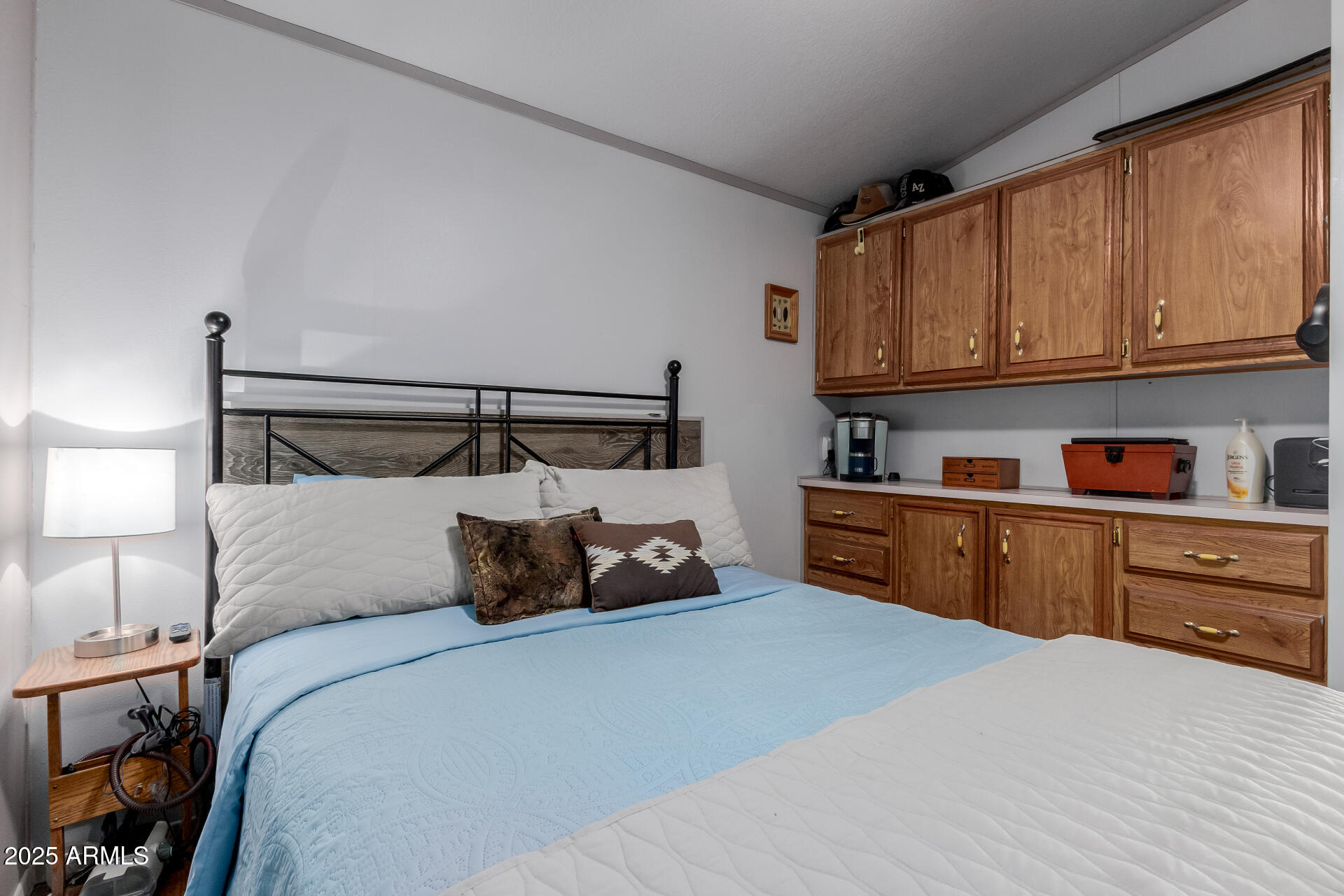 17200 West Bell Road, Unit 1233 Surprise, AZ 85374 - Photo 16 of 41 a bedroom with a bed and cabinets