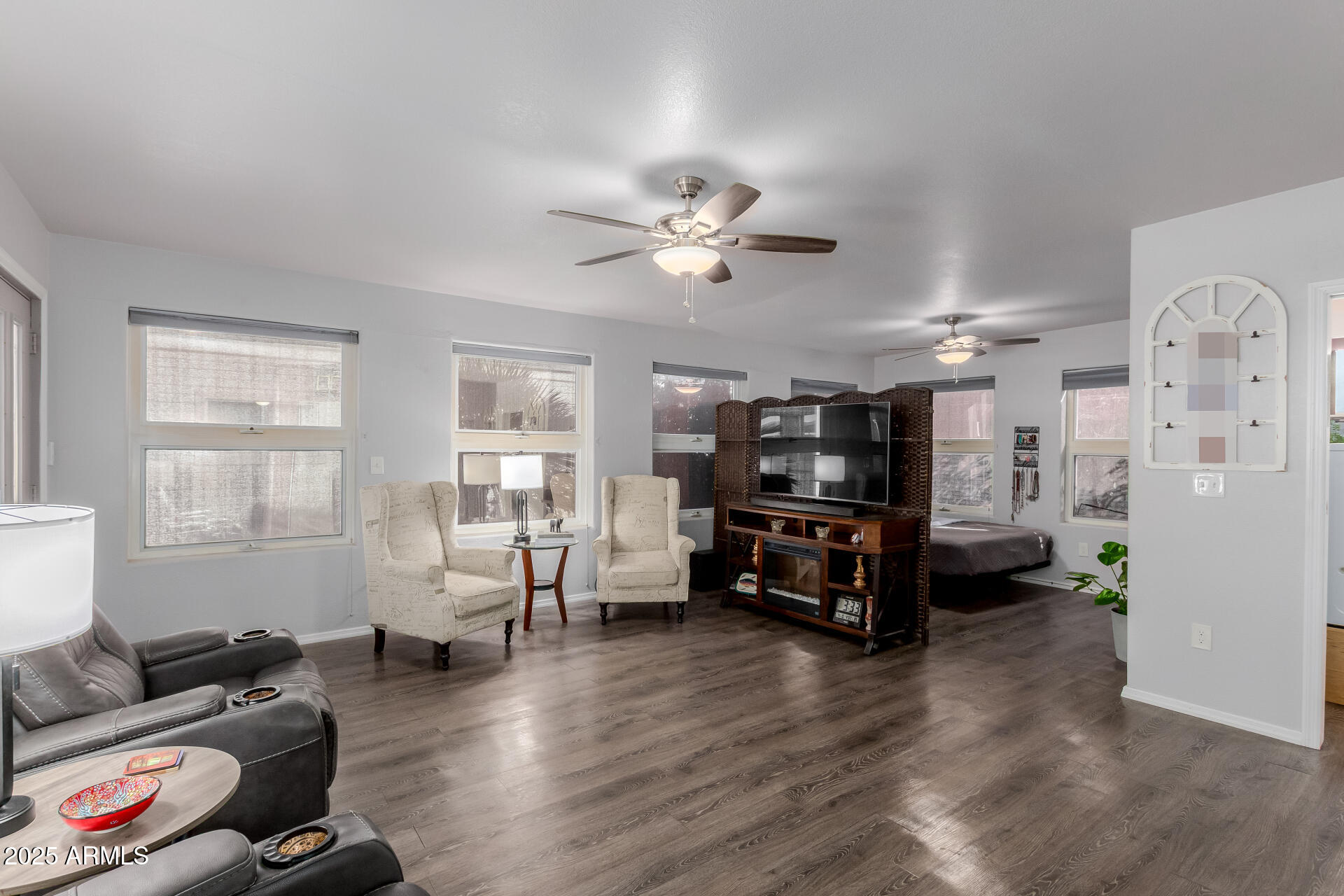 17200 West Bell Road, Unit 1233 Surprise, AZ 85374 - Photo 8 of 41 a living room with furniture and a chandelier