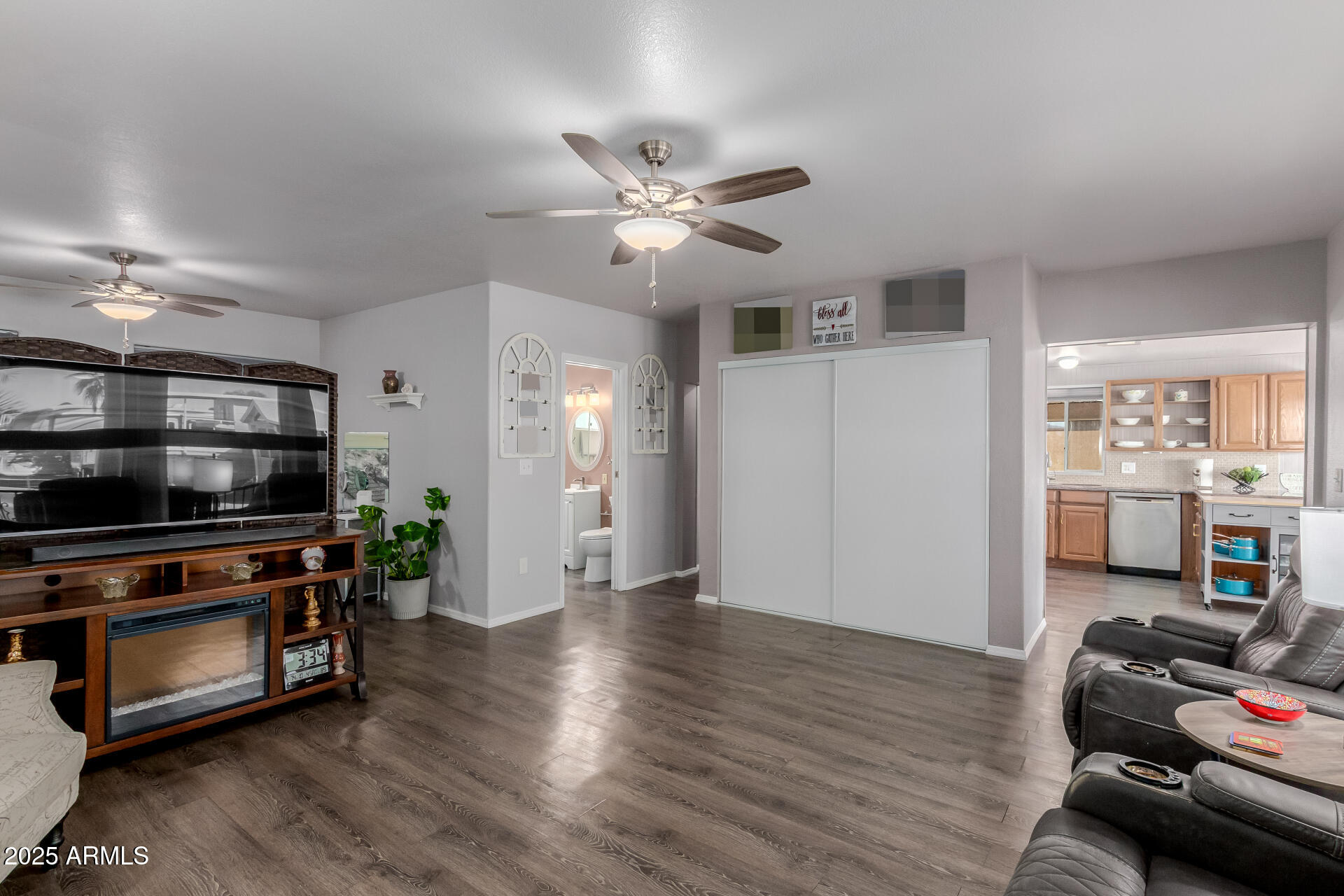 17200 West Bell Road, Unit 1233 Surprise, AZ 85374 - Photo 9 of 41 a view of a livingroom with furniture a ceiling fan and wooden floor