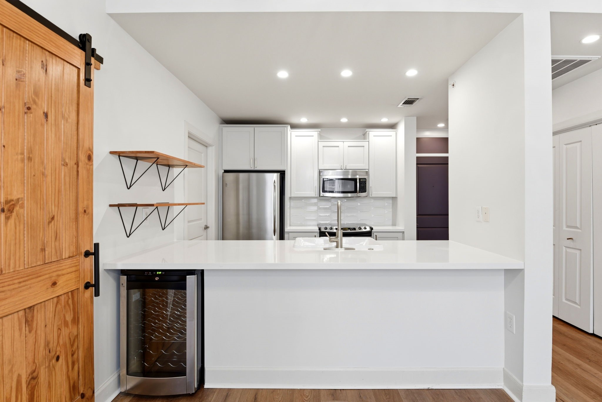 1010 Rosine Street, Unit 43 Houston, TX 77019 - Photo 16 of 48 a large kitchen with stainless steel appliances a refrigerator and a stove top oven