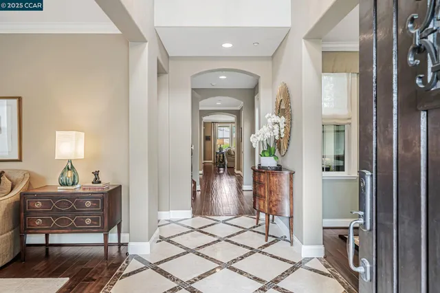 a living room with furniture a flat screen tv and a large window