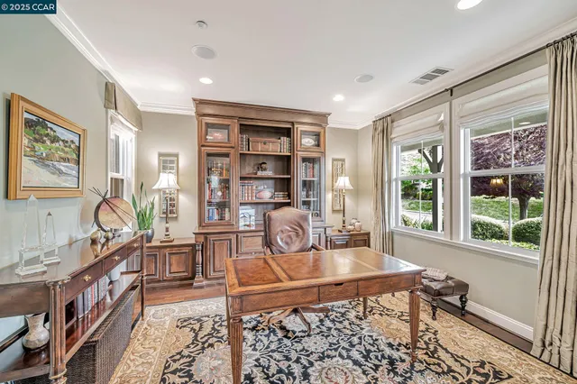 a living room with furniture a large window and a flat screen tv