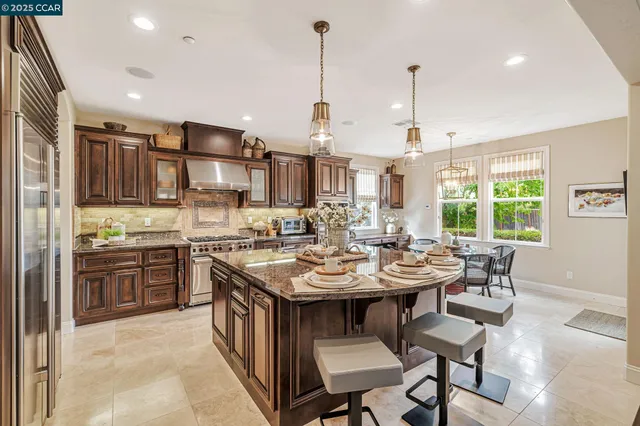 a kitchen with stainless steel appliances granite countertop a sink and cabinets