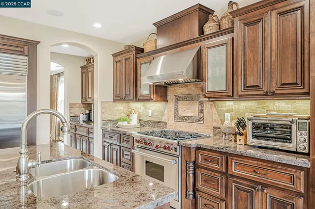 a view of a dining room with furniture a chandelier and wooden floor