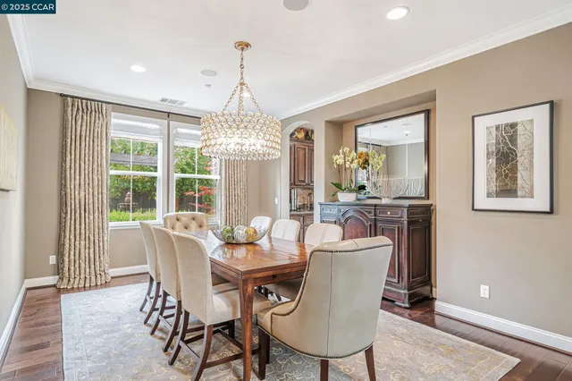 a dining room with furniture a chandelier and window