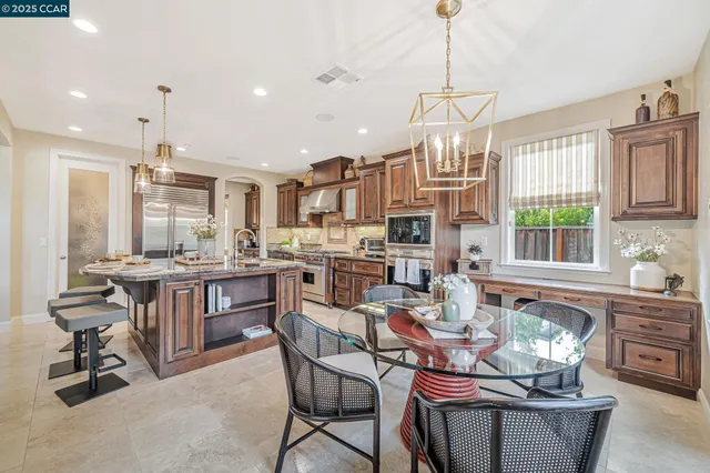 a bedroom with a large bed and a flat tv screen on dresser