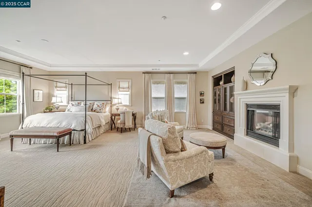 a spacious bedroom with a bed and a flat screen tv