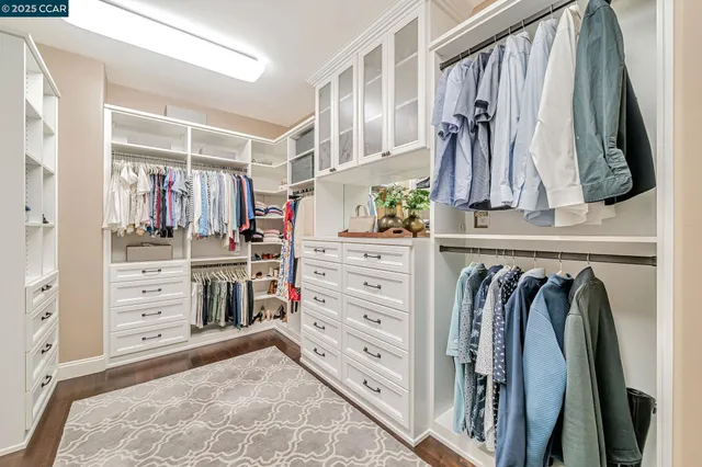a spacious bedroom with a bed and a chandelier