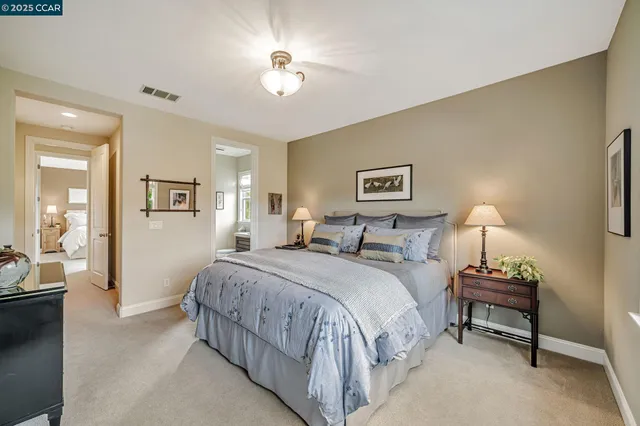 a bedroom with a bed and a tv on the dresser