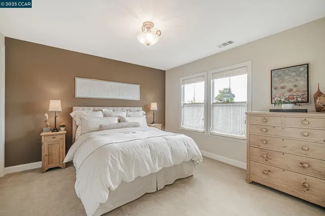 a bathroom with a granite countertop sink a toilet a mirror and shower