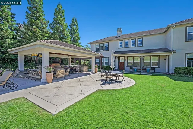 a view of a patio with table and chairs and potted plants