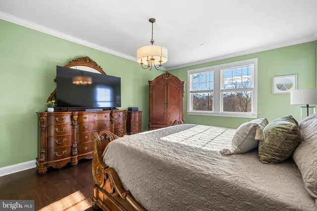a bedroom with a bed and a chandelier