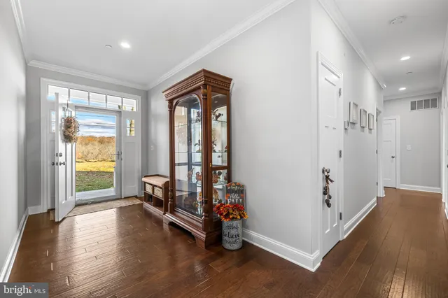 a view of a room with wooden floor and windows