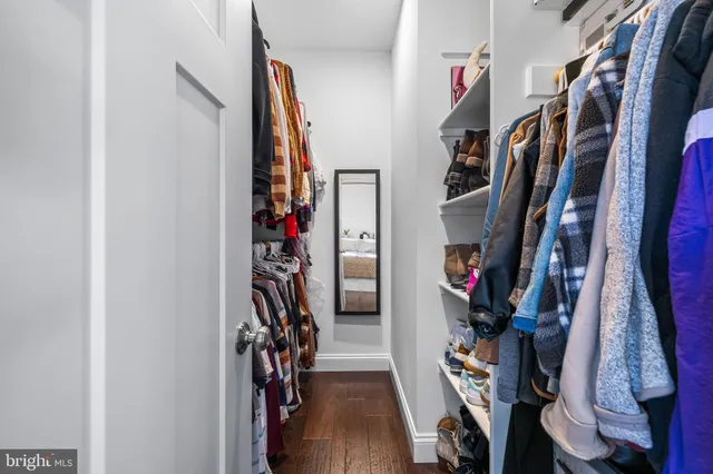 a view of walk in closet with clothes