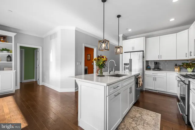 a kitchen with white cabinets and white appliances