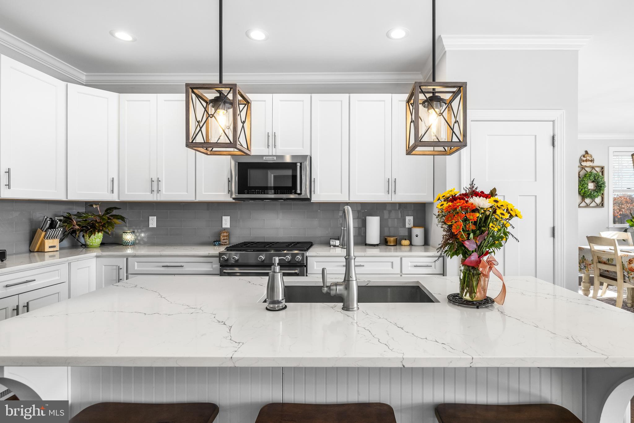 20834 Old York Road Parkton, MD 21120 - Photo 5 of 35 a kitchen with stainless steel appliances granite countertop a sink dishwasher and white cabinets with wooden floor