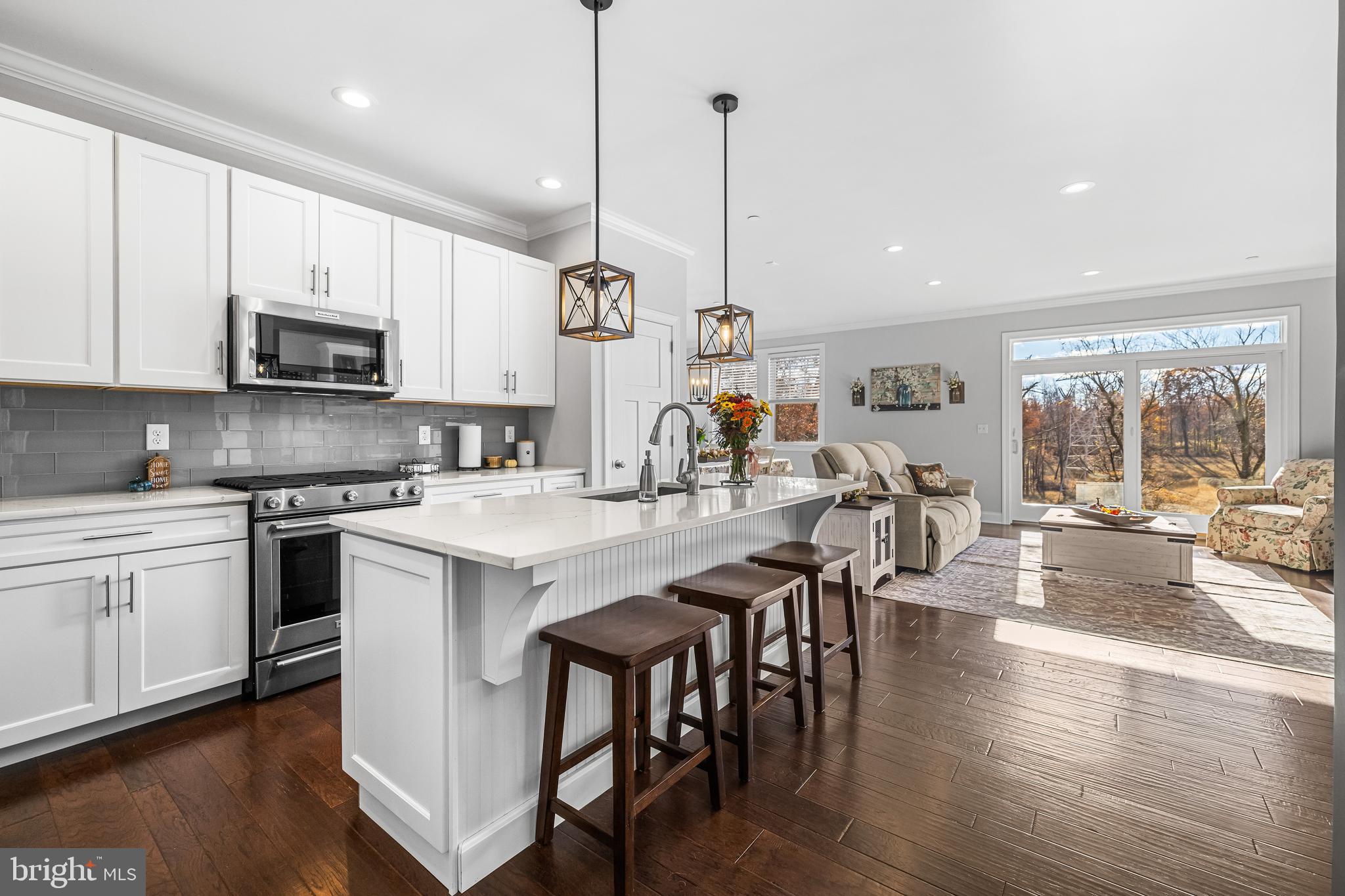 20834 Old York Road Parkton, MD 21120 - Photo 6 of 35 a kitchen with stainless steel appliances granite countertop a stove a sink a microwave a refrigerator a stove a kitchen island with a dining table and chairs