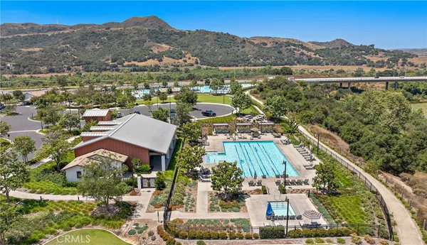 an aerial view of residential houses with outdoor space and river