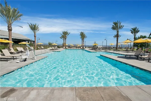 a view of a swimming pool with a yard and sitting area